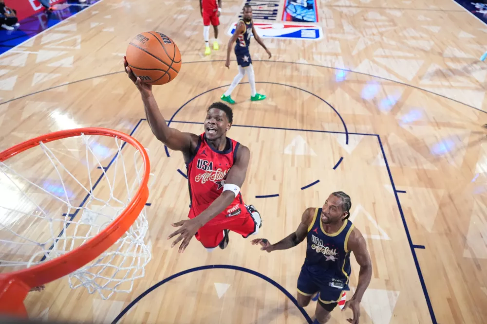 USA Stars guard Anthony Edwards drives past USA Stripes forward Kawhi Leonard in the NBA All-Star basketball game Sunday, Feb. 15, 2026, in Inglewood, Calif. (Ronald Martinez/Pool Photo via AP)