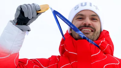 Milano Cortina 2026 Olympics - Alpine Skiing - Men's Slalom Victory Ceremony - Stelvio Ski Centre, Bormio, Italy - February 16, 2026. Gold medallist Loic Meillard of Switzerland celebrates on the podium during the men's slalom victory ceremony REUTERS/Denis Balibouse