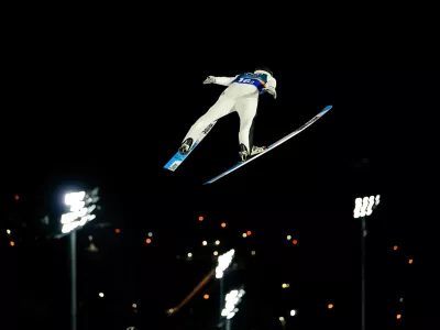 Domen Prevc, of Slovenia, soars through the air during his first round jump of the ski jumping men's super team competition at the 2026 Winter Olympics, in Predazzo, Italy, Monday, Feb. 16, 2026. (AP Photo/Matthias Schrader)