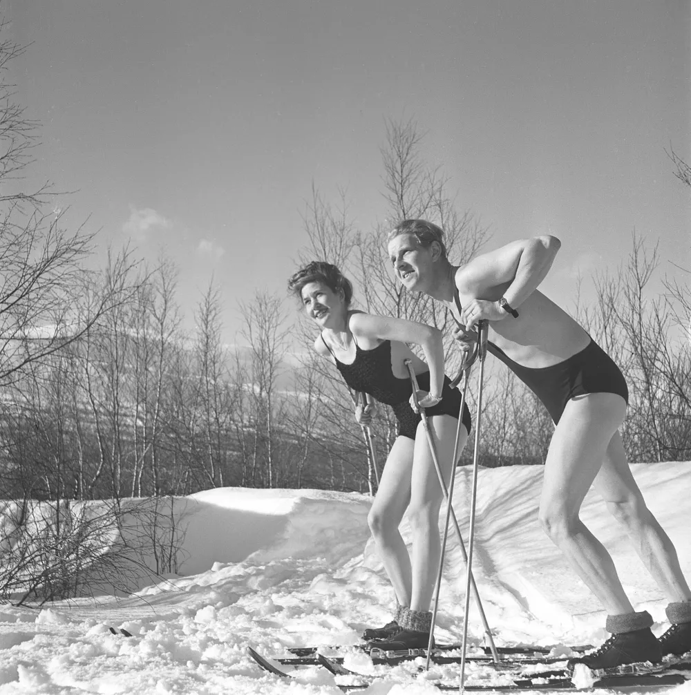 Winter in the 1940s. A young couple is enjoying their winter vacation, and they are wearing their swimsuits to get a nice tan from being outdoors in the warm sun. Sweden 1940s. Photo Kristoffersson Ref D115-4,Image: 978270210, License: Rights-managed, Restrictions:, Model Release: no
