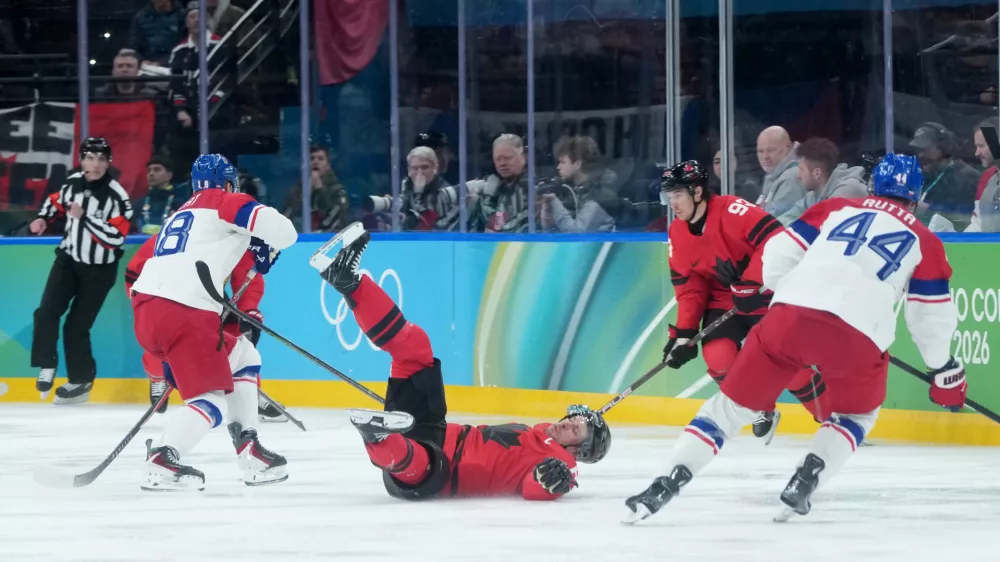 Canada's Sidney Crosby (87) falls after being checked by Czechia's Ondrej Palat (18) during the second period of a men's ice hockey quarterfinal game at the 2026 Winter Olympics, in Milan, Italy, Wednesday, Feb. 18, 2026. (Darryl Dyck/The Canadian Press via AP)