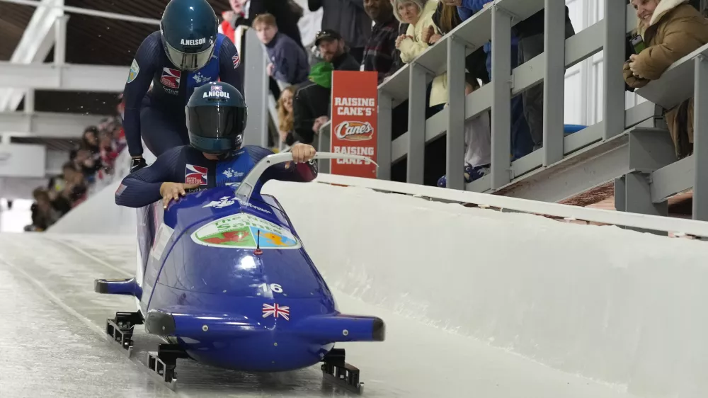 Britain's Adele Nicoll and Ashleigh Nelson, of the United States, start their first run of the 2-woman bobsled race during the bobsled world championships, Friday, March 14, 2025, in Lake Placid, N.Y. (AP Photo/Seth Wenig)