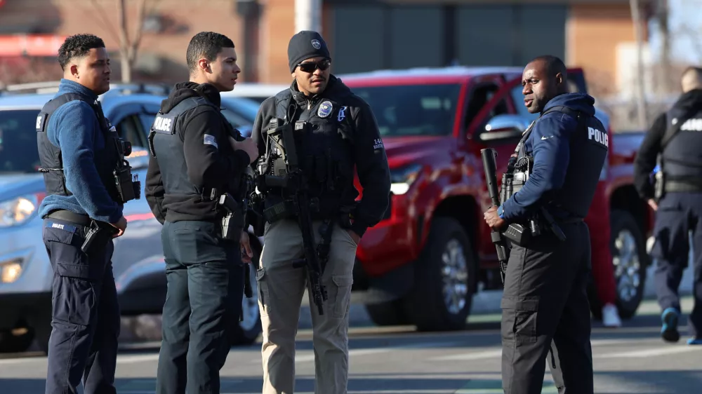 Police congregate near the Lynch Arena in Pawtucket, R.I., after a shooting occurred at the ice rink, Monday, Feb. 16, 2026. (AP Photo/Mark Stockwell)
