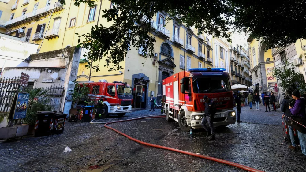 Firetrucks stand next to the historic wood-framed Teatro Sannazaro damaged by fire, in Naples, Italy, February 17, 2026. REUTERS/Ciro De Luca
