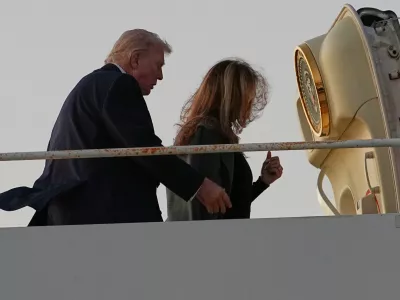 President Donald Trump and first lady Melania Trump board Air Force One at Palm Beach International Airport in West Palm Beach, Fla., Monday, Feb. 16, 2026. (AP Photo/Matt Rourke)