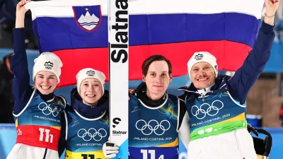 10 February 2026, Italy, Predazzo: (L-R) Slovenia's Nika Vodan, Nika Prevc, Domen Prevc and Anze Lanisek celebrate after the Ski Jumping Mixed team competition of the 2026 Winter Olympic Games at Milan-Cortina. Photo: Daniel Karmann/dpa