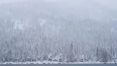Snow comes down on a forest and cabins along Donner Lake during a storm Thursday, Feb. 19, 2026, near Truckee, Calif. (AP Photo/Godofredo A. Vásquez)