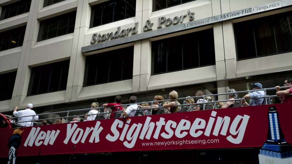 FILE - In this Aug. 6, 2011 photo, tourists drive past Standard & Poor's headquarters in New York's financial district Saturday, Aug. 6, 2011. (AP Photo/Karly Domb Sadof, File)