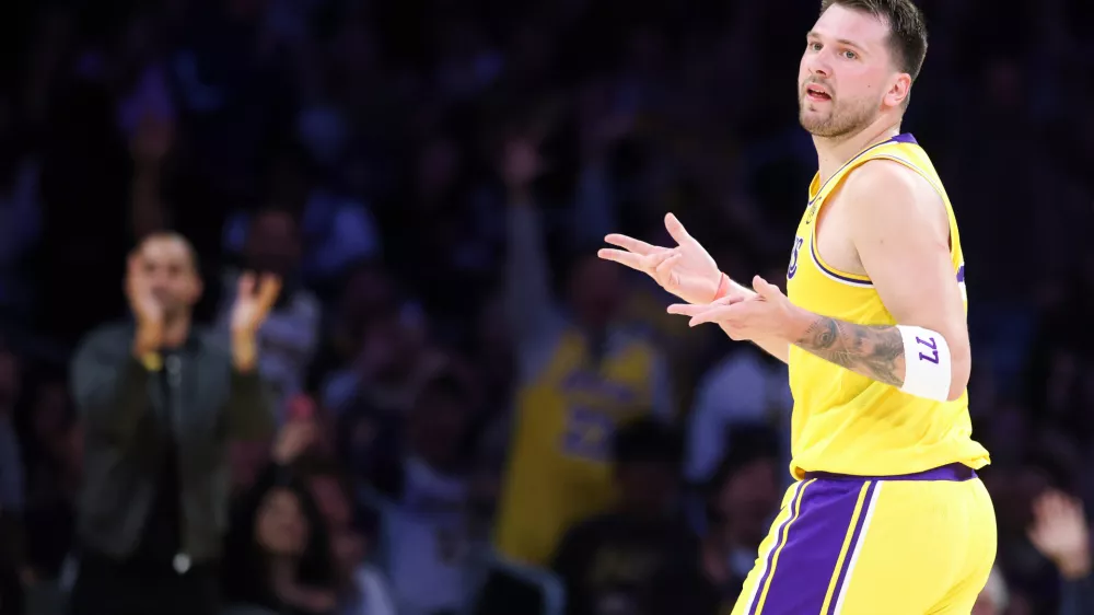 Los Angeles Lakers guard Luka Doncic gestures after scoring a 3-point basket against the Los Angeles Clippers during the first half of an NBA basketball game, Friday, Feb. 20, 2026, in Los Angeles. (AP Photo/Jessie Alcheh)