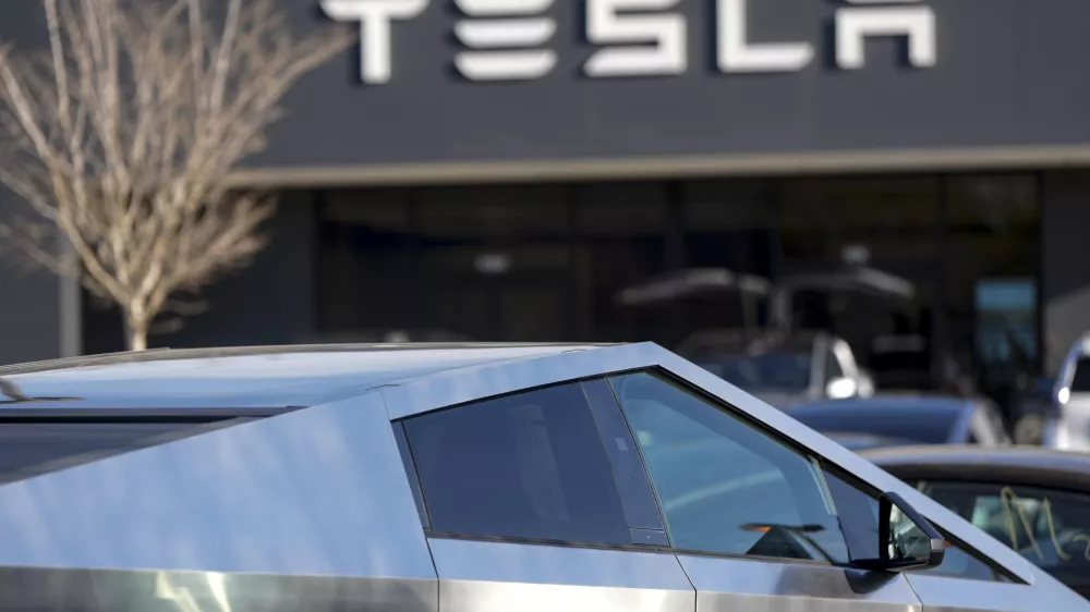 A Tesla Cybertruck and other Telsla vehicles sit at a dealership, Wednesday, March 19, 2025, in Kennesaw, Ga. (AP Photo/Mike Stewart)