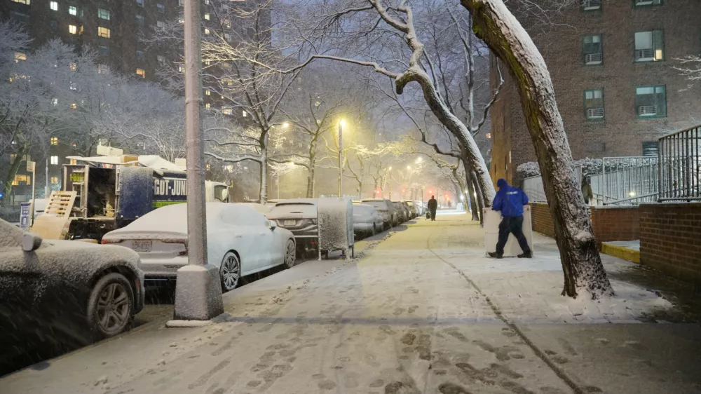 A man works in a snowstorm, Sunday, Feb. 22, 2026, in New York. (AP Photo/Pamela Hassell)