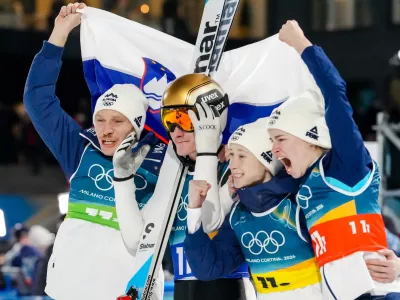 Nika Vodan, from right, Nika Prevc, Domen Prevc, and Anze Lanisek, of Slovenia, celebrate after winning the gold medal in the ski jumping mixed team competition at the 2026 Winter Olympics, in Predazzo, Italy, Tuesday, Feb. 10, 2026. (AP Photo/Evgeniy Maloletka)