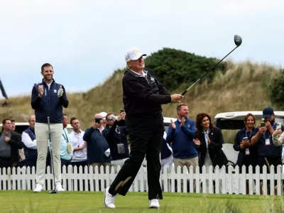 Eric Trump applauds as his father, U.S. President Donald Trump, tees off, on the day of the grand opening of Trump International Golf Links Aberdeen in Balmedie, Aberdeen, Scotland, Britain, July 29, 2025. REUTERS/Evelyn Hockstein