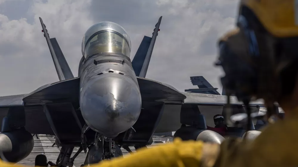 This handout photograph from the U.S. Navy shows Aviation Boatswain's Mate 2nd Class Michael Cordova directing an F/A-18F Super Hornet on the flight deck of the Nimitz-class aircraft carrier USS Abraham Lincoln in the Indian Ocean on Jan. 23, 2026. (Mass Communication Specialist Seaman Daniel Kimmelman/U.S. Navy via AP)