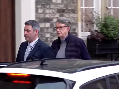 Former British Ambassador to the U.S. Peter Mandelson is led away from his home by a police officer as he is arrested on suspicion of misconduct in public office, following revelations over his ties to convicted sex offender Jeffrey Epstein, in London, Britain, February 23, 2026, in this screen capture from video. BBC/Pool via REUTERS THIS IMAGE HAS BEEN SUPPLIED BY A THIRD PARTY. NO RESALES. NO ARCHIVES. MANDATORY CREDIT. UNITED KINGDOM OUT. NO COMMERCIAL OR EDITORIAL SALES IN UNITED KINGDOM