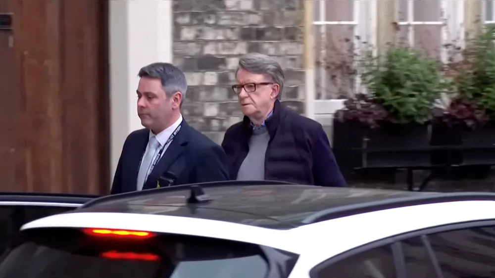 Former British Ambassador to the U.S. Peter Mandelson is led away from his home by a police officer as he is arrested on suspicion of misconduct in public office, following revelations over his ties to convicted sex offender Jeffrey Epstein, in London, Britain, February 23, 2026, in this screen capture from video. BBC/Pool via REUTERS THIS IMAGE HAS BEEN SUPPLIED BY A THIRD PARTY. NO RESALES. NO ARCHIVES. MANDATORY CREDIT. UNITED KINGDOM OUT. NO COMMERCIAL OR EDITORIAL SALES IN UNITED KINGDOM
