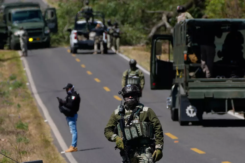 A soldier clears a roadblock on a road leading to Tapalpa, Mexico, Monday, Feb. 23, 2026, a day after the Mexican army killed Jalisco New Generation Cartel leader Nemesio Oseguera Cervantes, known as "El Mencho." (AP Photo/Marco Ugarte)