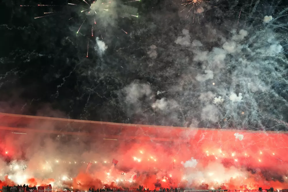 Red Star fans light fireworks during a Serbian National soccer league derby match between Red Star and Partizan in Belgrade, Serbia, Sunday, Feb. 22, 2026. (AP Photo/Darko Vojinovic)