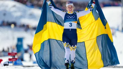 Ebba Andersson, of Sweden, celebrates after winning the gold medal in the cross country skiing women's 50km mass start classic at the 2026 Winter Olympics, in Tesero, Italy, Sunday, Feb. 22, 2026. (AP Photo/Matthias Schrader)