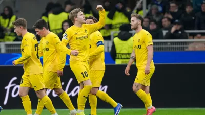 Glimt's Jens Petter Hauge, center, celebrates with team mates after scoring his side's first goal during a Champions League playoff soccer match between Inter Milan and Bodo Glimt, at the San Siro stadium in Milan, Italy, Tuesday, Feb.24, 2026. (AP Photo/Luca Bruno)