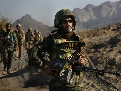 Soldiers from the Afghan National Army, and Canadian soldiers from 3rd Bat, Royal 22nd Regiment of Valcartier, Quebec return from a patrol in the town of Panjwayi in the Kandahar province of Afghanistan Thursday, Nov. 23, 2006. (AP Photo/David Guttenfelder)