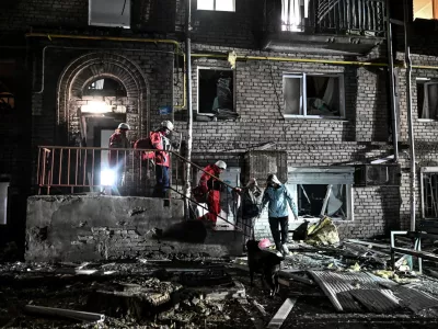 Rescuers evacuate residents from a damaged apartment building hit by a Russian drone strike, amid Russia's attack on Ukraine, in Zaporizhzhia, Ukraine February 24, 2026. REUTERS/Stringer