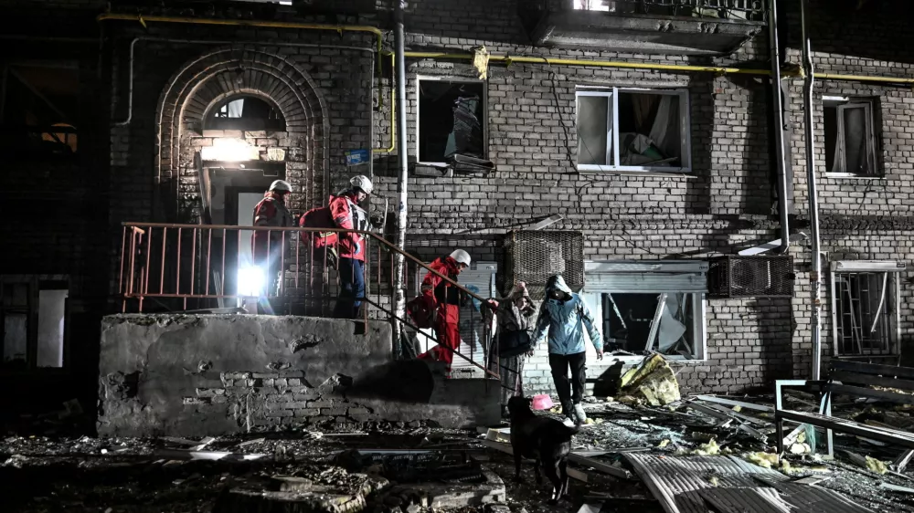 Rescuers evacuate residents from a damaged apartment building hit by a Russian drone strike, amid Russia's attack on Ukraine, in Zaporizhzhia, Ukraine February 24, 2026. REUTERS/Stringer