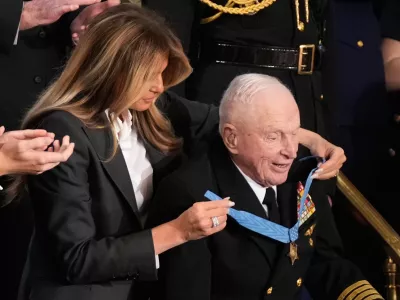 First lady Melania Trump awards World War II Navy pilot Capt. Royce Williams the Congressional Medal of Honor as President Donald Trump delivers the State of the Union address to a joint session of Congress in the House chamber at the U.S. Capitol in Washington, Tuesday, Feb. 24, 2026. (AP Photo/Mark Schiefelbein)