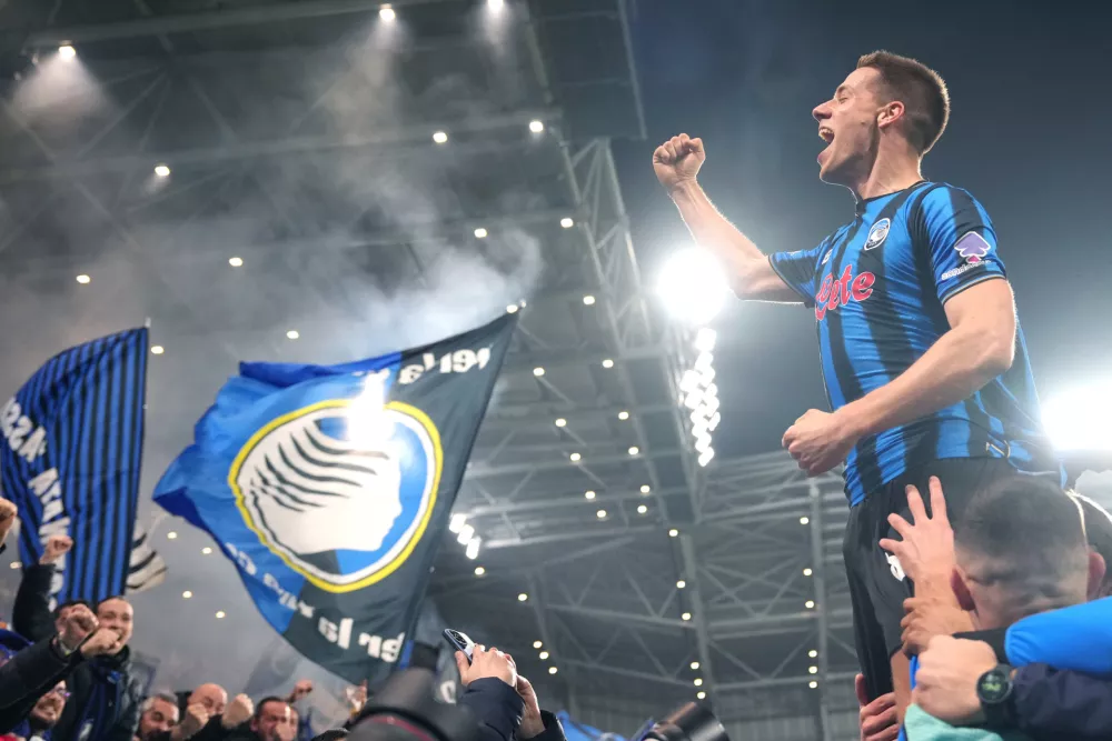 Atalanta's Mario Pasalic celebrates after scoring their third goal during the Champions League second leg playoff match between Atalanta and Borussia Dortmund in Bergamo, Italy, Wednesday, Feb. 25, 2026. (Spada/LaPresse via AP)