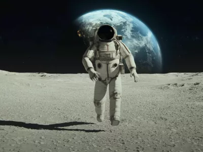 Earth Planet as seen from Moon surface. The surface of Moon, strewn with small rocks and sand. Flight over Moon craters. Lunar outpost in the distance. Apollo Mission inspired. Following Shot of Brave Astronaut in Space Suit Confidently Walking on the Moon Surface. Space Planet as viewed from Moon surface. The surface of the moon, strewn with small rocks and sand. Flight over Moon craters. Moon surface, Desert, Cliffs, sand. Covered in Rocks. First Astronaut On the Moon Surface. Big Moment for the Human Race. Advanced Technologies, Space Exploration/ Travel, Colonisation Concept. NASA Public Domain Imagery. https://www.solarsystemscope.com/textures/ https://svs.gsfc.nasa.gov/cgi-bin/details.cgi?aid=4720 / Foto: Nzoka John