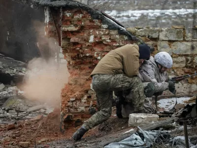 An Instructor pushes a recruit of the 28th Separate Mechanized Brigade of the Armed Forces of Ukraine during a grenade explosion during a military exercise before combat missions, amid Russia's attack on Ukraine, in Kharkiv region, Ukraine February 26, 2026. REUTERS/Sofiia Gatilova
