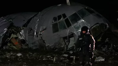 A military police stands next to a plane that crashed in El Alto, Bolivia, Friday, Feb. 27, 2026. (AP Photo/Juan Karita)