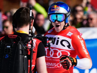 Switzerland's Marco Odermatt reacts at the finish area, during a men's World Cup downhill race, in Garmisch Partenkirchen, Germany, Saturday, Feb. 28, 2026. (AP Photo/Giovanni Auletta)