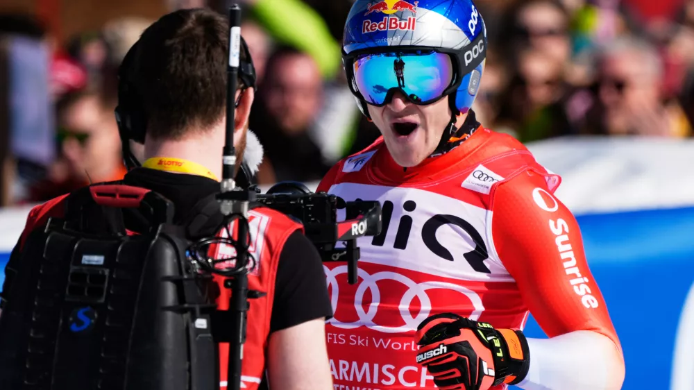Switzerland's Marco Odermatt reacts at the finish area, during a men's World Cup downhill race, in Garmisch Partenkirchen, Germany, Saturday, Feb. 28, 2026. (AP Photo/Giovanni Auletta)