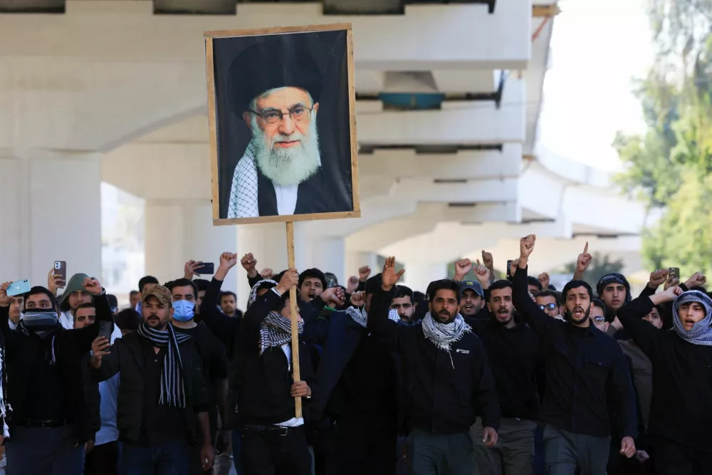 Protesters supporting Iraqi Shi'ite armed groups demonstrate near the entrance of the Green Zone after the killing of Iran's Supreme Leader Ayatollah Ali Khamenei, in Baghdad, Iraq, March 1, 2026. REUTERS/Thaier Al-Sudani