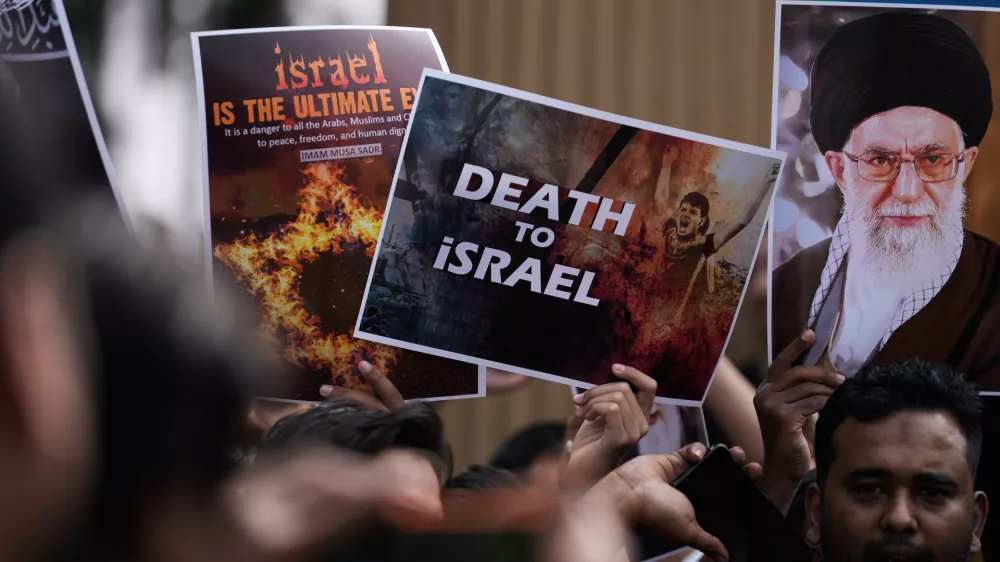 A Shiite Muslims holds a photograph of Iran's Supreme Leader Ayatollah Ali Khamenei during a protest against the U.S. and Israel in Hyderabad, India, Sunday, March 1, 2026. (AP Photo/Mahesh Kumar A.)