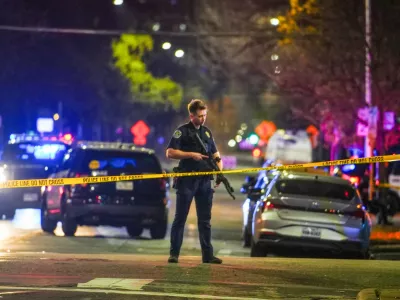 An Austin police officer guards the scene on West 6th Street at West Avenue after a shooting, Sunday March 1, 2026, in Austin, Texas. (Ricardo B. Brazziell/Austin American-Statesman via AP)