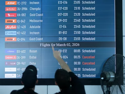 Passengers looks at departure board at I Gusti Ngurah Rai International Airport as some flights to Dubai and Doha cancelled following strikes on Iran launched by the United States and Israel, in Kuta, Bali, Indonesia, March 1, 2026. REUTERS/Johannes Christo
