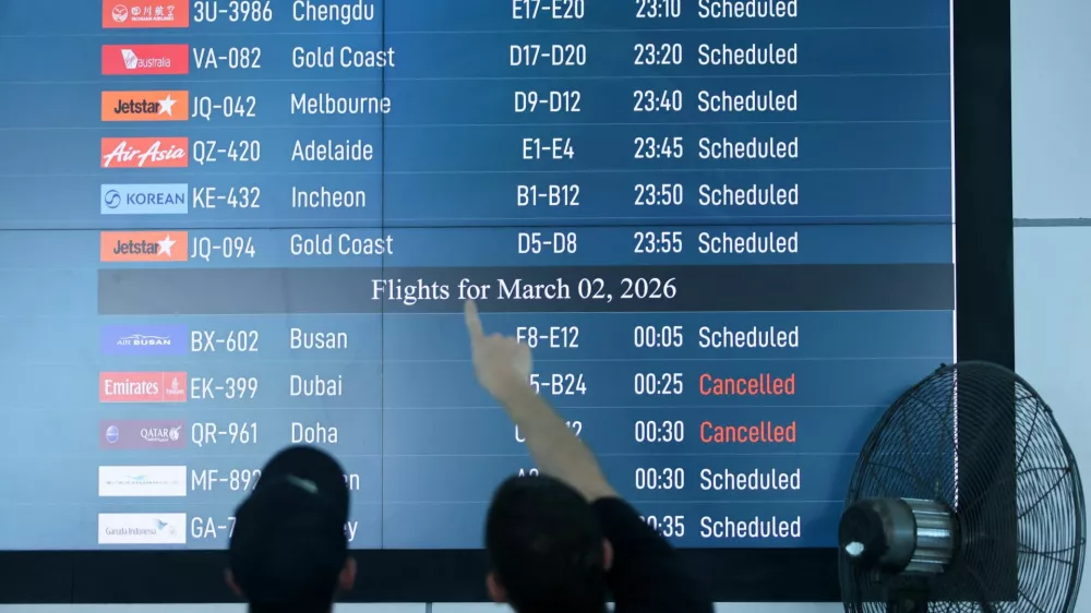 Passengers looks at departure board at I Gusti Ngurah Rai International Airport as some flights to Dubai and Doha cancelled following strikes on Iran launched by the United States and Israel, in Kuta, Bali, Indonesia, March 1, 2026. REUTERS/Johannes Christo