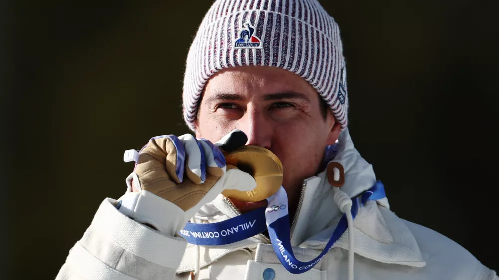 Milano Cortina 2026 Olympics - Biathlon - Men's 10km Sprint Victory Ceremony - Anterselva Biathlon Arena, South Tyrol, Italy - February 13, 2026. Gold medallists Quentin Fillon Maillet of France celebrates on the podium after winning Men's 10km Sprint REUTERS/Eloisa Lopez