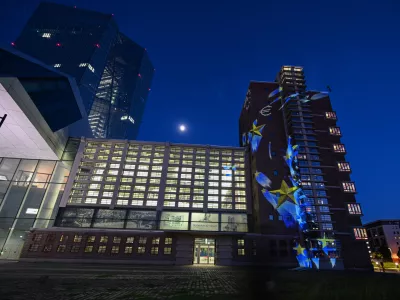 FILED - 08 May 2025, Hesse, Frankfurt/Main: Images of stars and euro signs are projected onto part of the former Frankfurt Grossmarkthalle at the European Central Bank (ECB). Photo: Arne Dedert/dpa