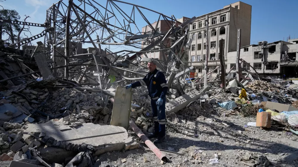 An electricity utility worker inspects the ruins of a police facility struck during the U.S.&ndash;Israeli military campaign in Tehran, Iran, Wednesday, March 4, 2026. (AP Photo/Vahid Salemi)