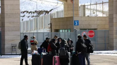 Iranians stand at the Kapikoy Border Gate as they wait to cross from Turkey into Iran, in the eastern province of Van, Turkey, March 4, 2026. REUTERS/Dilara Senkaya