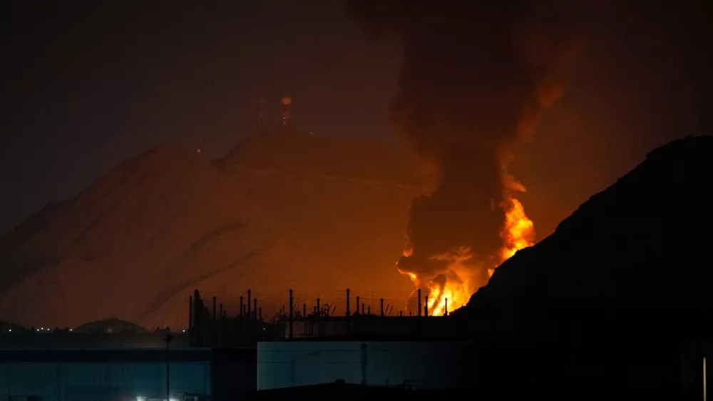 Large fire and plume of smoke is visible after, according to the authorities, debris of an Iranian intercepted drone hit the Fujairah oil facility, in Fujairah, United Arab Emirates, Tuesday, March 3, 2026. (AP Photo/Altaf Qadri)