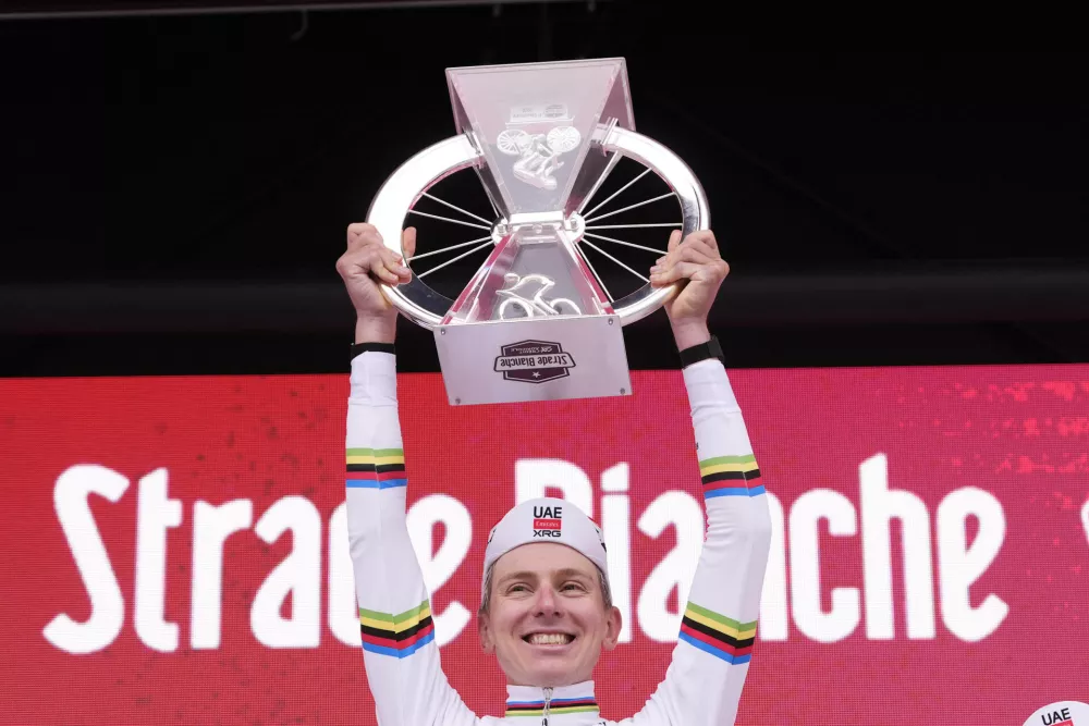 Tadej Pogacar of Team UAE Emirates celebrates winning the Strade Bianche (White Roads), a 203 km one day cycling race from and to Siena, Italy, Saturday March 7, 2026. (Fabio Ferrari/LaPresse via AP)