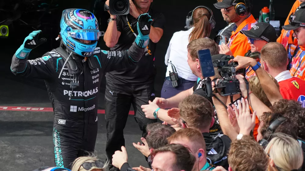 Mercedes driver George Russell of Britain celebrates to his team after winning the Australian Formula One Grand Prix at Albert Park, in Melbourne, Australia, Sunday, March 8, 2026. (AP Photo/Scott Barbour)