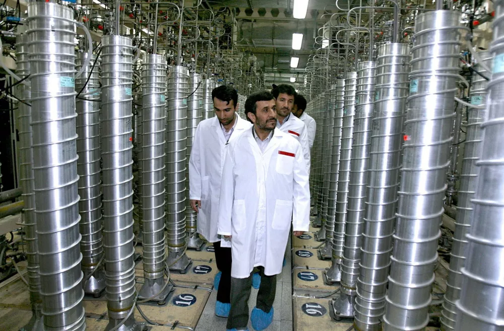 FILE - In this April 8, 2008 file photo provided by the Iranian President's Office, Iranian President Mahmoud Ahmadinejad, center, visits the Natanz Uranium Enrichment Facility some 200 miles (322 kilometers) south of the capital Tehran. Iran has begun uranium enrichment at a new underground site well protected from possible airstrikes, a leading hardline newspaper reported Sunday, Jan. 8, 2011. (AP Photo/Iranian President's Office, File) NO SALES
