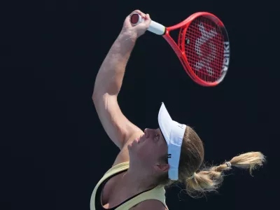 Veronika Erjavec of Slovenia serves to Magdalena Frech of Poland during their first round match at the Australian Open tennis championship in Melbourne, Australia, Monday, Jan. 19, 2026. (AP Photo/Dar Yasin)