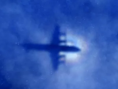 The shadow of a Royal New Zealand Air Force (RNZAF) P3 Orion maritime search aircraft can be seen on low-level clouds as it flies over the southern Indian Ocean looking for missing Malaysian Airlines flight MH370 in this March 31, 2014 file photo. Malaysia is "almost certain" that plane debris found on Reunion Island in the Indian Ocean is from a Boeing 777, the deputy transport minister said on July 30, 2015, heightening the possibility it could be wreckage from missing Flight MH370. REUTERS/Rob Griffith/Pool/Files