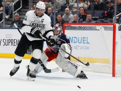 Columbus Blue Jackets' Jet Greaves, right, deflects the puck away from Los Angeles Kings' Anze Kopitar during the second period of an NHL hockey game, Monday, March 9, 2026, in Columbus, Ohio. (AP Photo/Jay LaPrete)